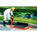 Man in hazmat suit placing Sellars orange spill berm around drain.